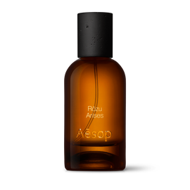 Amber glass Aesop Rozu Arises Eau de Parfum bottle with black cap on a white background.