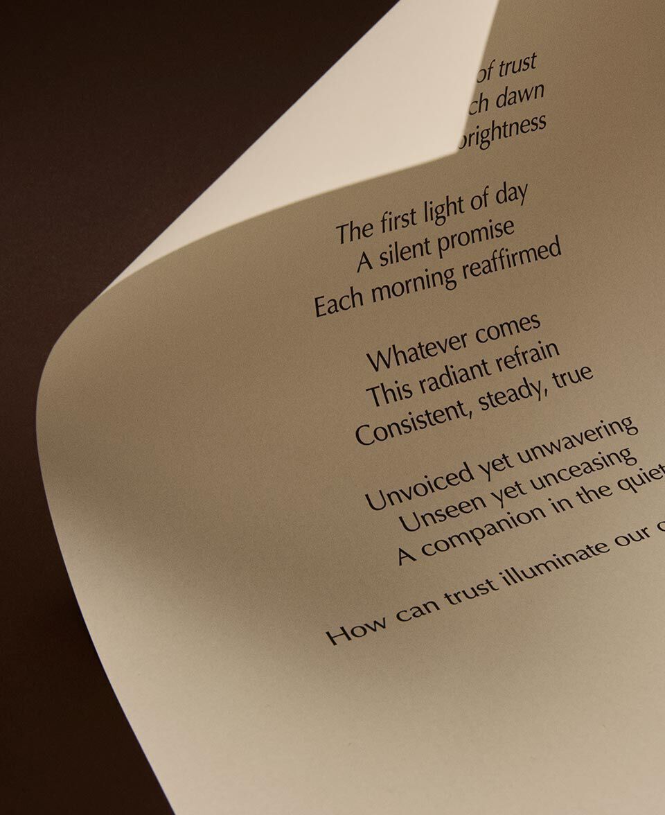 Curled cream page featuring poem text in a close-up composition.