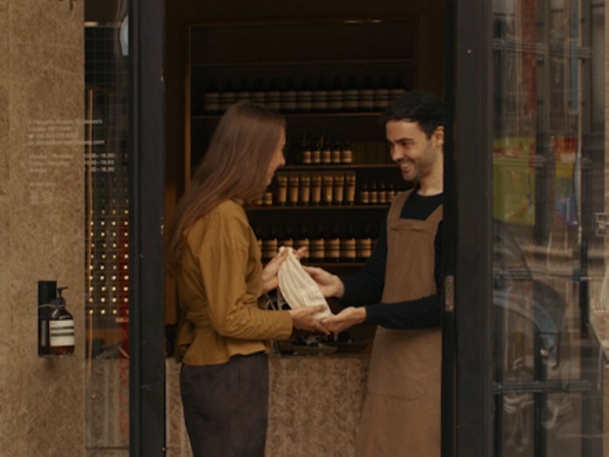 A hand care consultation in an Aesop store, beside a complimentary 15mL Eleos Aromatique Hand Balm offered upon email subscription.