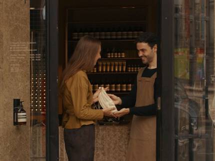 A hand care consultation in an Aesop store, beside a complimentary 15mL Eleos Aromatique Hand Balm offered upon email subscription.